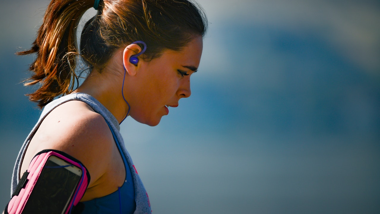 woman-wearing-smartphone-armband-and-blue-earphones-2291874.jpg