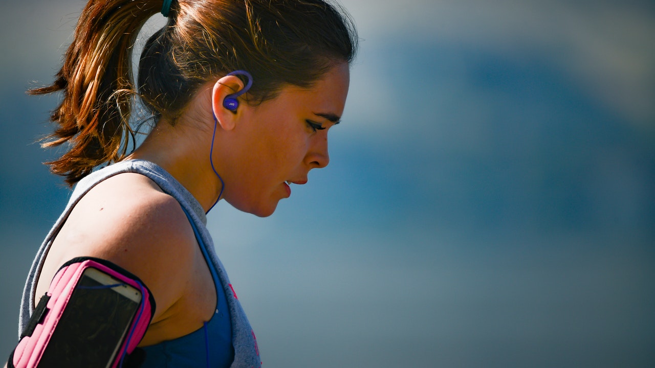 woman-wearing-smartphone-armband-and-blue-earphones-2291874.jpg